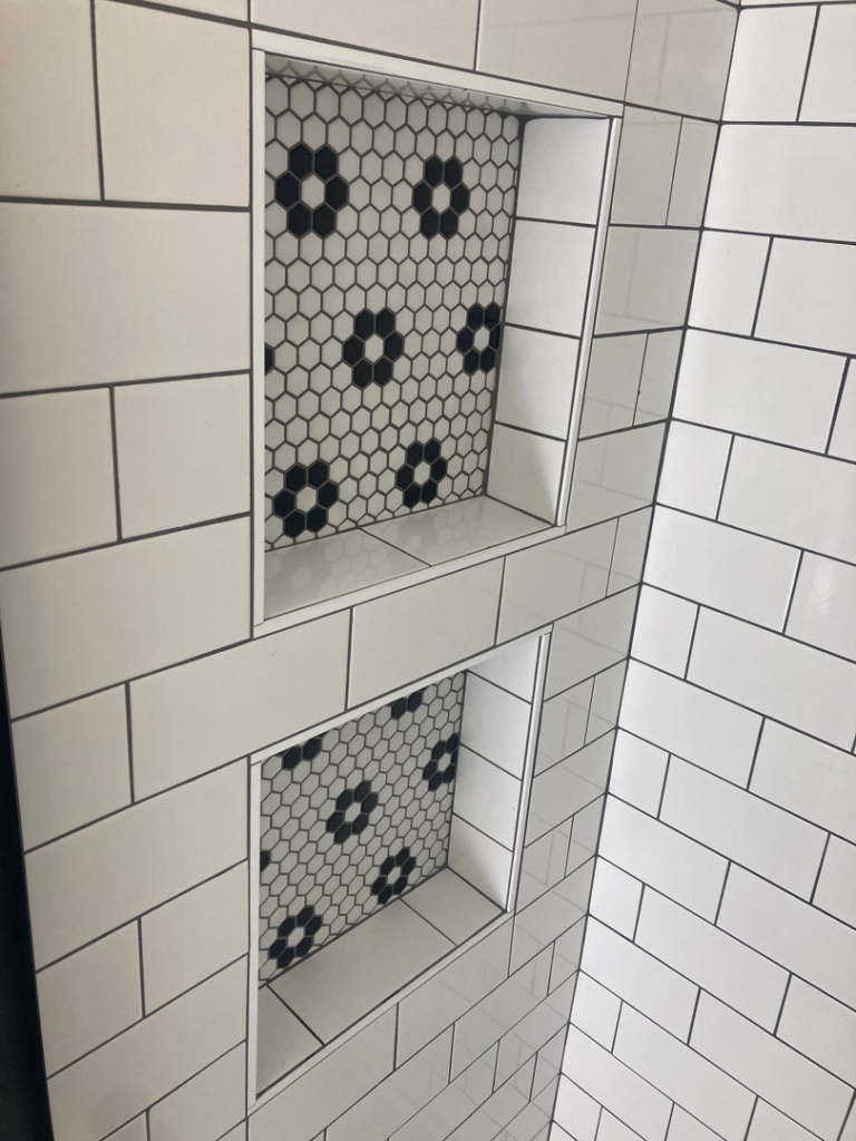 Custom subway tile shower niches with decorative hexagon accents by Davis Home Dynamics in Springfield, OR