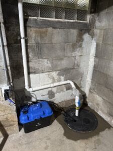 A newly installed sump pump system in a basement by The Basement Doctor in Reynoldsburg, OH.