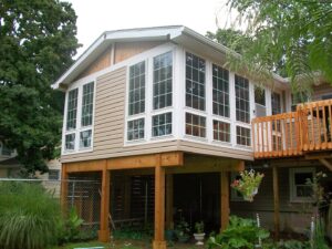A newly constructed sunroom addition with large windows, built by Mainville Construction & Remodeling LLC in Newington, CT.