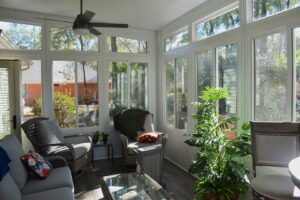 A bright sunroom addition with large windows and comfortable seating, constructed by NRG Industries in Tallahassee, FL.