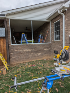 A sunroom construction site with power tools and ladders, showing work in progress by Western Kentucky Sunrooms in Bowling Green, KY.