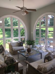 A bright sunroom with large arched windows, ideal for UV control services by Augusta Sun & UV Control in Augusta, GA.