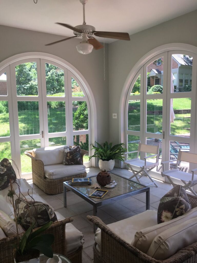 A bright sunroom with large arched windows, ideal for UV control services by Augusta Sun & UV Control in Augusta, GA.