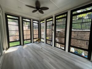 A sunroom interior with light grey flooring and equipment, showing recent work by X-Terior Techs in Henrico, VA.