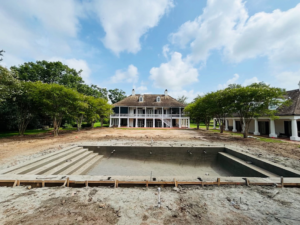 A swimming pool under construction with its concrete shell and steps visible by GW Oliver Aquatics in Baton Rouge, LA.