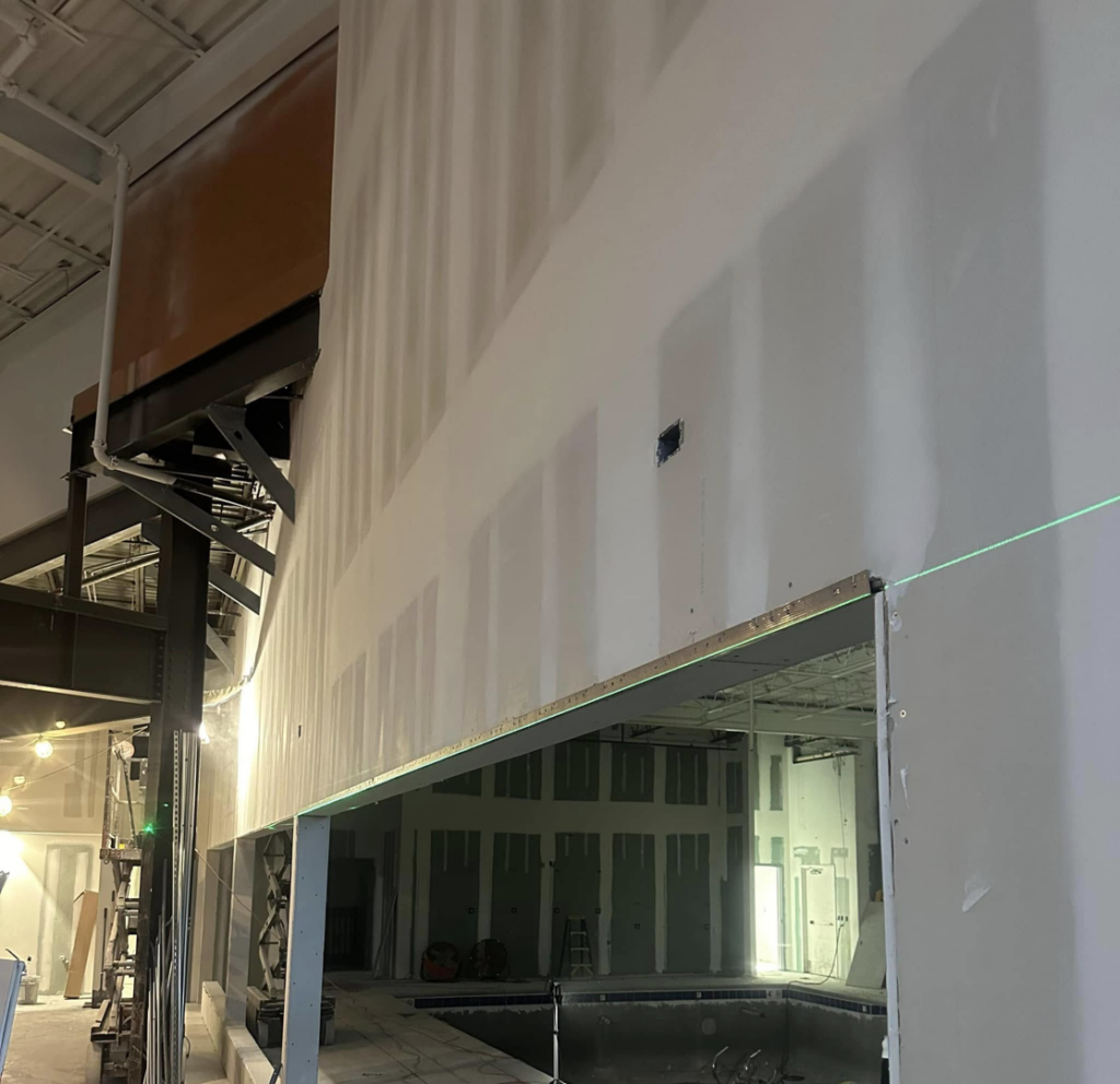 Tall wall drywall installation and mudding in a commercial space by Husky drywall LLC in Kansas City, MO.