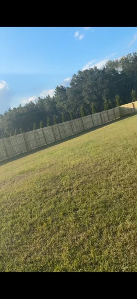 A tall, newly installed wooden privacy fence providing backyard seclusion by Fence & Deck Connection, Inc. in Savannah, GA.