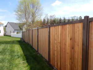 Durable tall wooden privacy fence with dark posts installed for a residential property by National Fence Systems, Inc. in Avenel, NJ.