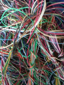 A close-up view of tangled colorful electrical wires, ready for recycling by RZR Recycling in Phoenix, AZ.