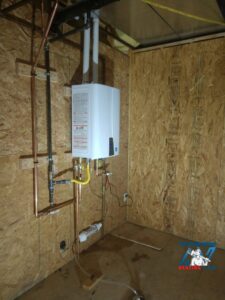A newly installed tankless water heater with copper and PVC piping by Top-Notch Plumbing, Heating & Air in Greeley, CO.