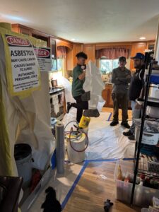 A team of workers preparing for asbestos abatement in a kitchen by Asbestos Abatement, Inc in Englewood, CO.