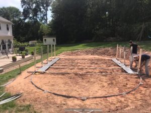 A team of professionals assembling the metal frame for an above-ground pool installation by Advanced Pools and Repair, LLC in Bristol, CT.