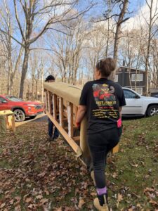A team from Just Junk It in Lancaster, PA, hauling an old sofa frame from a residential property for removal.