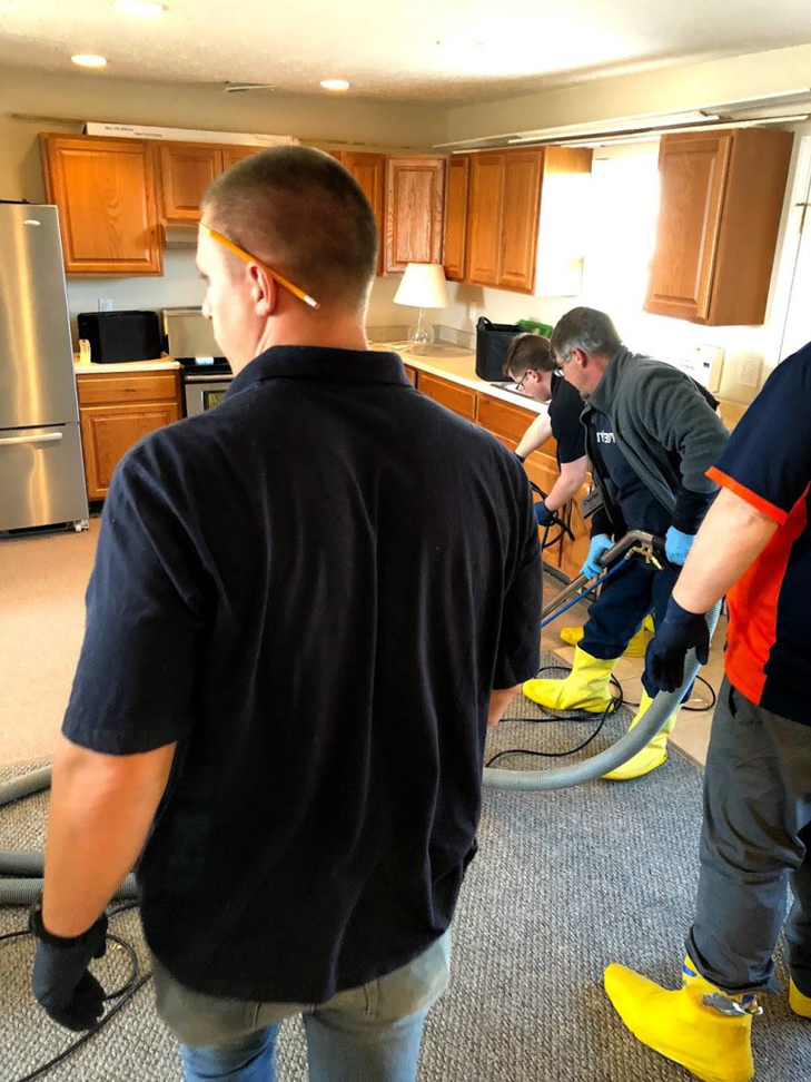 A team of ProTouch Restoration handymen performing restoration services in a kitchen in Minneapolis, MN.