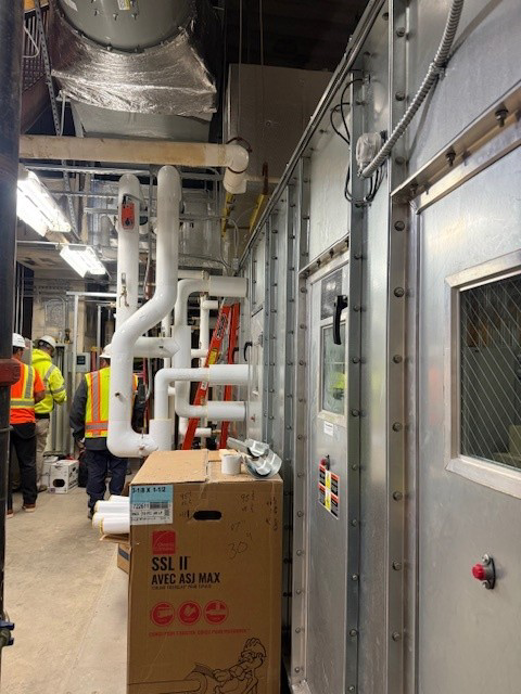 A team of workers in safety gear performing maintenance in a commercial facility for StructSure Projects in Kansas City, MO.