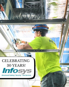 A technician installing structured cabling overhead for OESCO - Oklahoma Electrical Supply Co & Infosys in Oklahoma City, OK