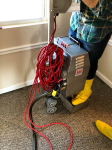 A ProTouch Restoration technician operating a professional carpet cleaning machine in Minneapolis, MN.