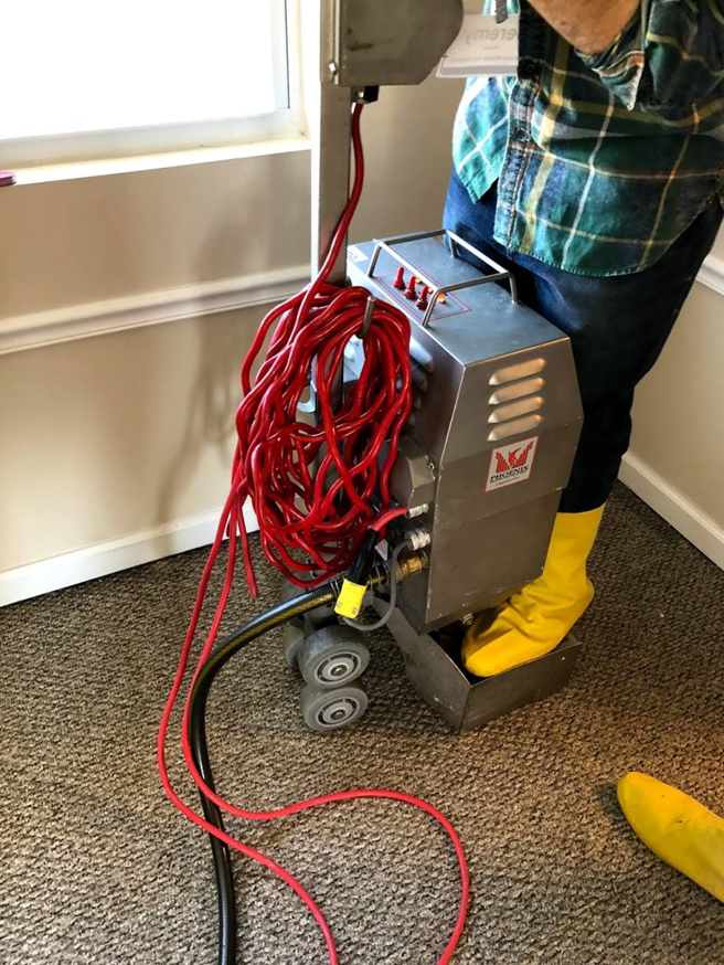 A ProTouch Restoration technician operating a professional carpet cleaning machine in Minneapolis, MN.