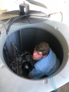 A technician repairing an outdoor air conditioning unit for Frankie's Air-Conditioning in Alexandria, LA.