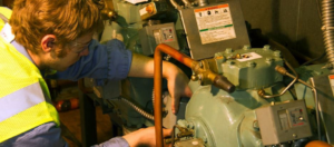 A technician repairing an HVAC or refrigeration unit for Paschal Construction LLC in Memphis, TN.