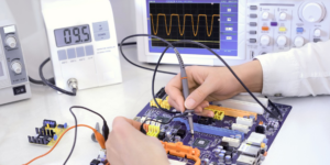 A technician testing an electronic circuit board as part of the recycling process at Global Electronic Recycling in Phoenix, AZ.