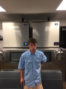 A technician standing in front of commercial ice machines serviced by Frankie's Air-Conditioning in Alexandria, LA.