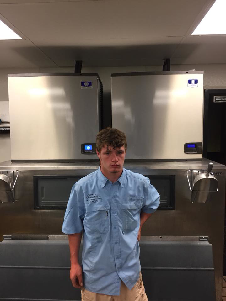 A technician standing in front of commercial ice machines serviced by Frankie's Air-Conditioning in Alexandria, LA.