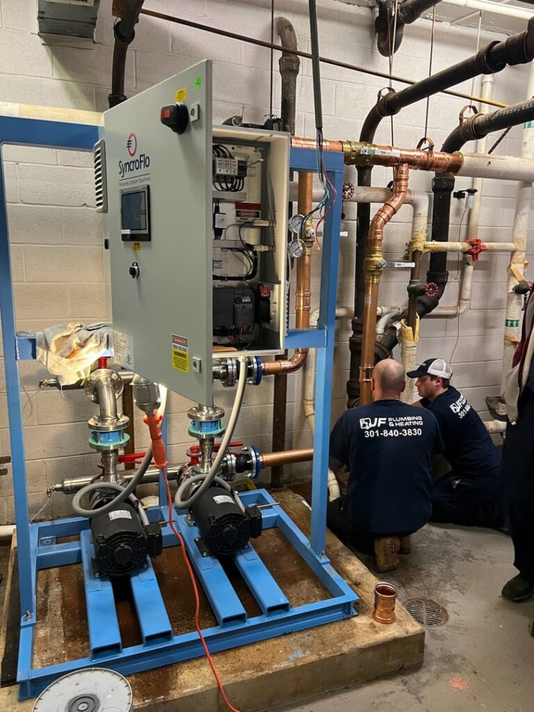 Technicians from JF Plumbing & Heating working on an industrial plumbing system in Rockville, MD.
