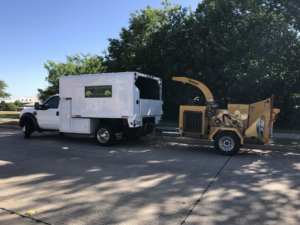 A Texas Tree Services truck with a wood chipper ready for tree removal in Fort Worth, TX.