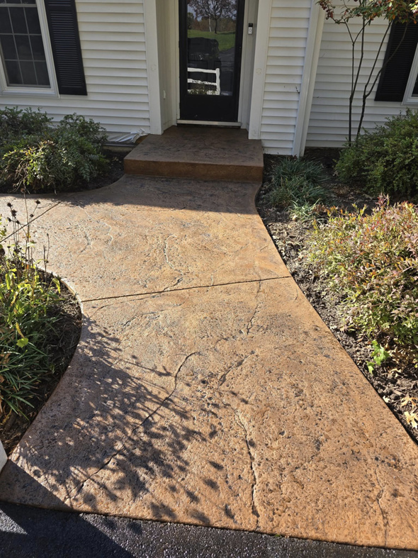 A textured stamped concrete walkway and entrance steps for a home, built by J&M Concrete Construction, LLC in Fayetteville, PA.