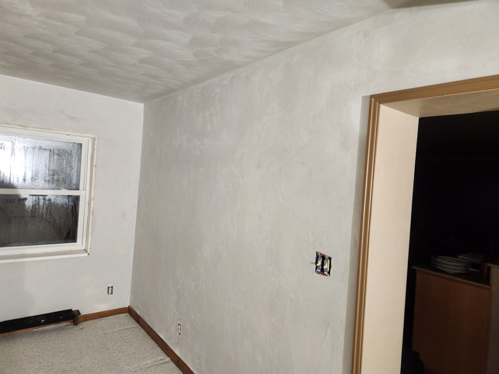 A room with newly applied textured wall and ceiling finish by Collins Plastering in Deland, FL