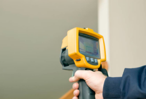 A technician performing thermal imaging to diagnose energy loss at Home Energy Diagnostics in Montclair, NJ