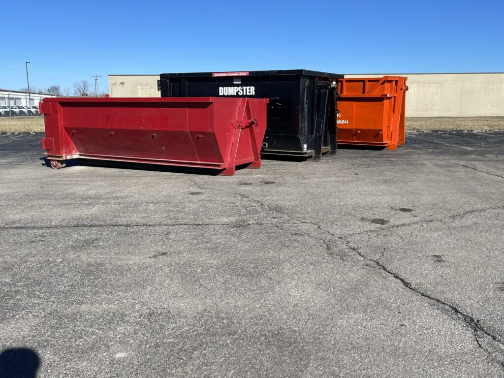 Three empty dumpsters in red, black, and orange, ready for junk removal services from Lil Man W/A Can LLC in Columbus, OH.