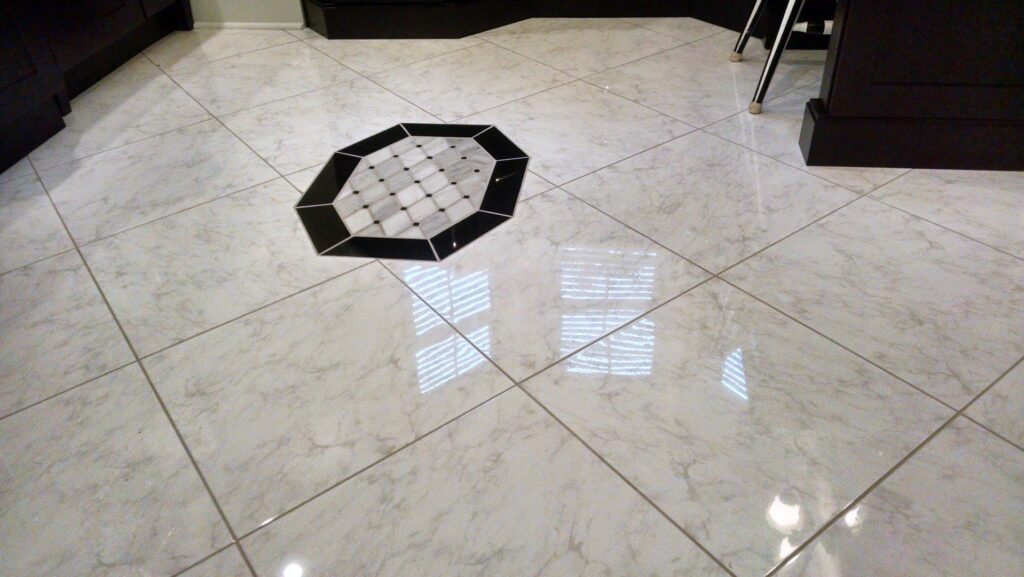 A newly installed tile floor with a decorative octagonal inlay by Unique Construction Services in Knoxville, TN