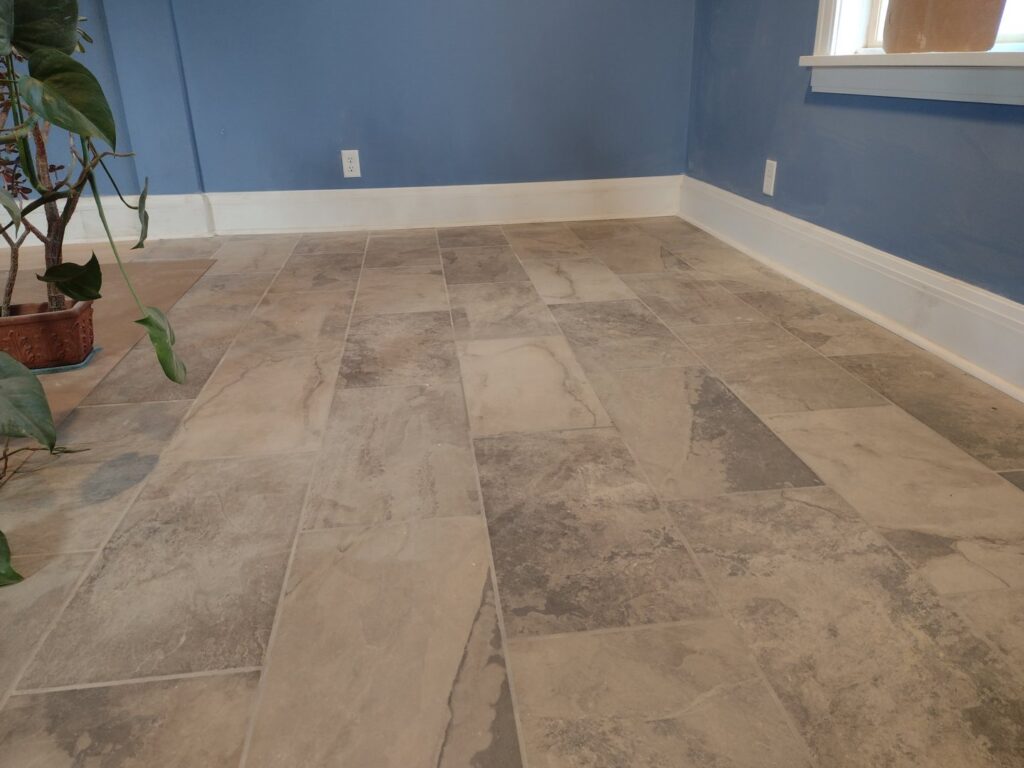 A room featuring newly installed tile flooring and fresh blue interior painting by Surfaces By Design in Duluth, MN.