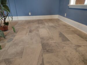 A room featuring newly installed tile flooring and fresh blue interior painting by Surfaces By Design in Duluth, MN.