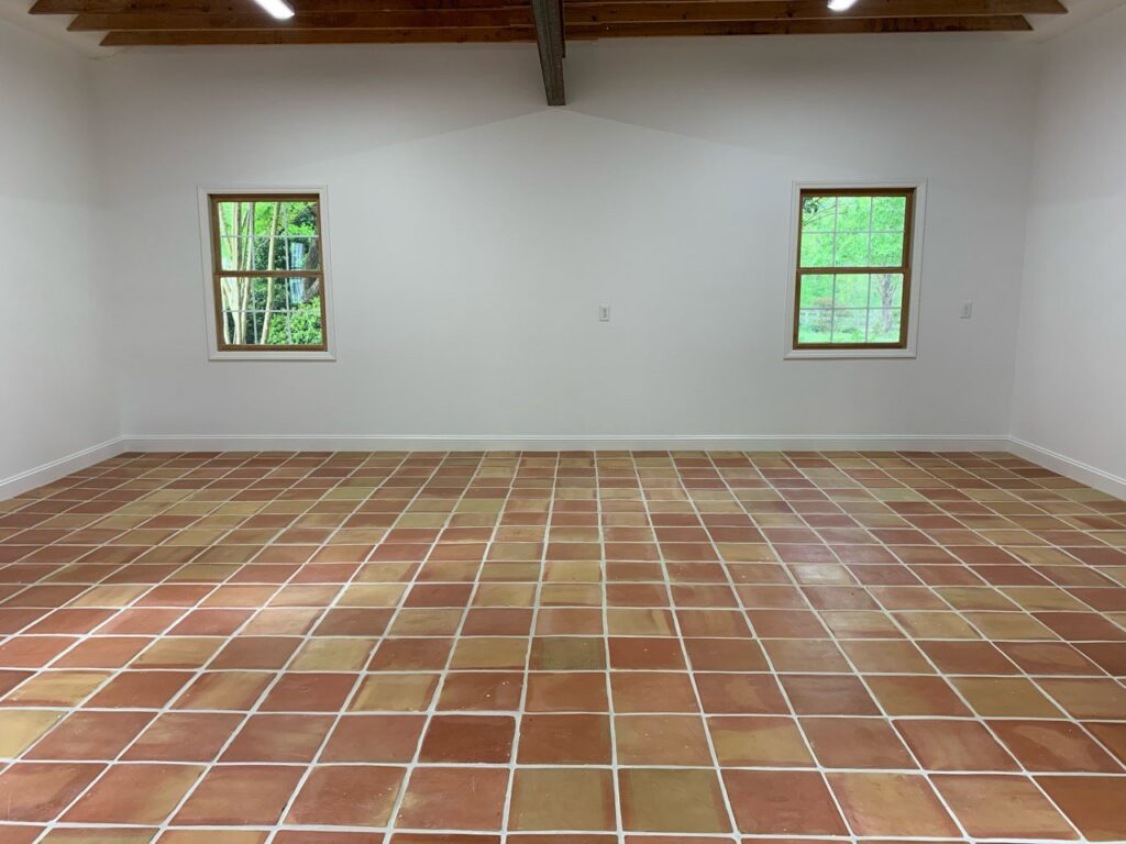Newly installed tile flooring in an empty room by KC's Improvement & Construction Co., Inc. in Greensboro, NC