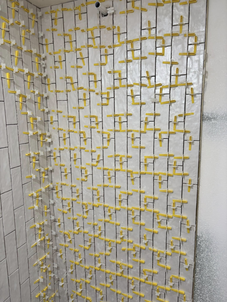 Tile installation in progress on a shower wall, a service provided by Considerate Repair in Walla Walla, WA.