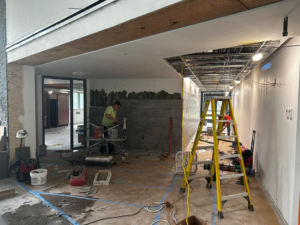 A tile installer working on a wall at a construction site for BRB Ceramic Tile & Marble in Metuchen, NJ