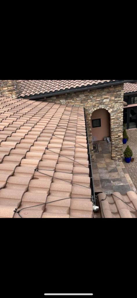 A tiled roof with heating or lighting wires installed, showing a completed handyman project by John's Helping Hand in Sparks, NV