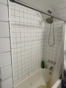 A newly tiled shower and bathtub area with modern fixtures, completed by T-N-T Mechanical in Westland, MI.