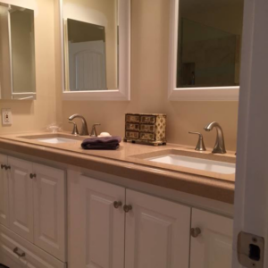 A newly installed tiled shower stall with a pebble floor and built-in niche by Holland Construction LLC in Tucson, AZ.