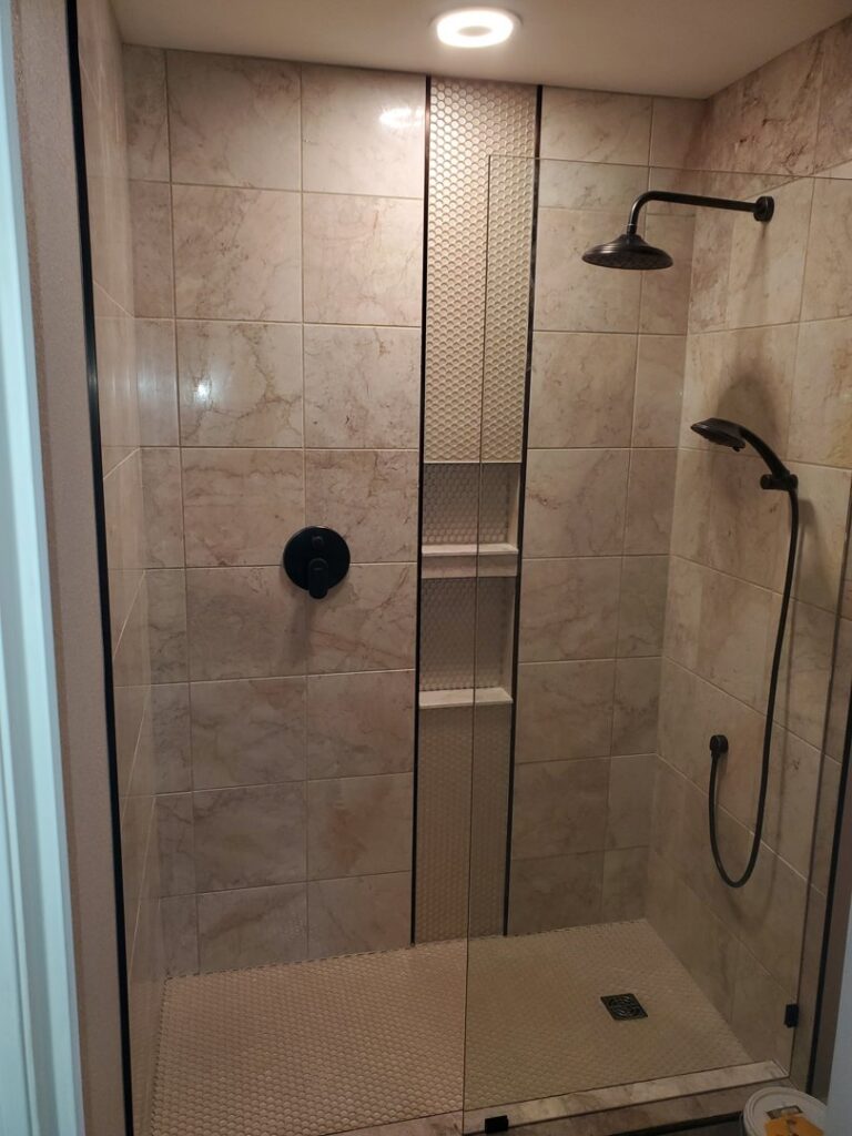 A newly tiled shower with modern fixtures installed by Rapid Repairs and Renovations in Knoxville, TN.