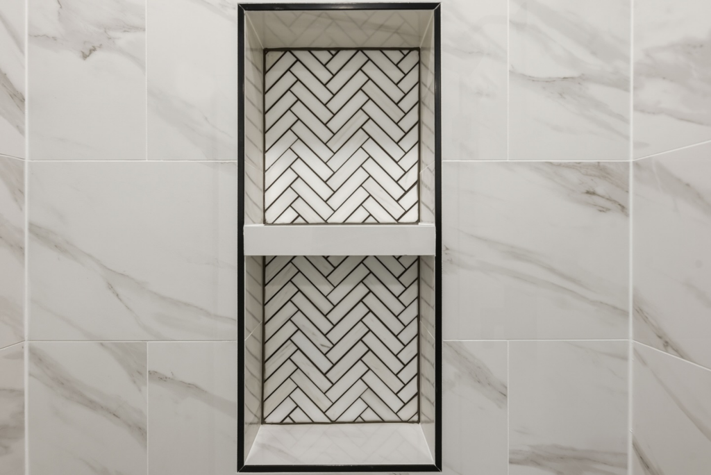 A beautifully tiled shower niche with a herringbone pattern, completed by BelRed Construction in Bellevue, WA.