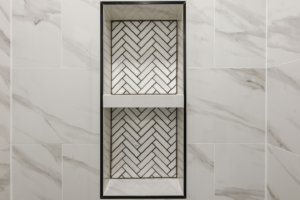 A beautifully tiled shower niche with a herringbone pattern, completed by BelRed Construction in Bellevue, WA.