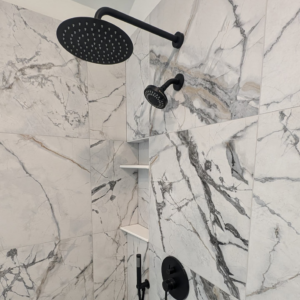 Luxurious tiled shower with a rain shower head and handheld sprayer by Ensotile - Atlanta Bathroom Remodeling in Stone Mountain, GA