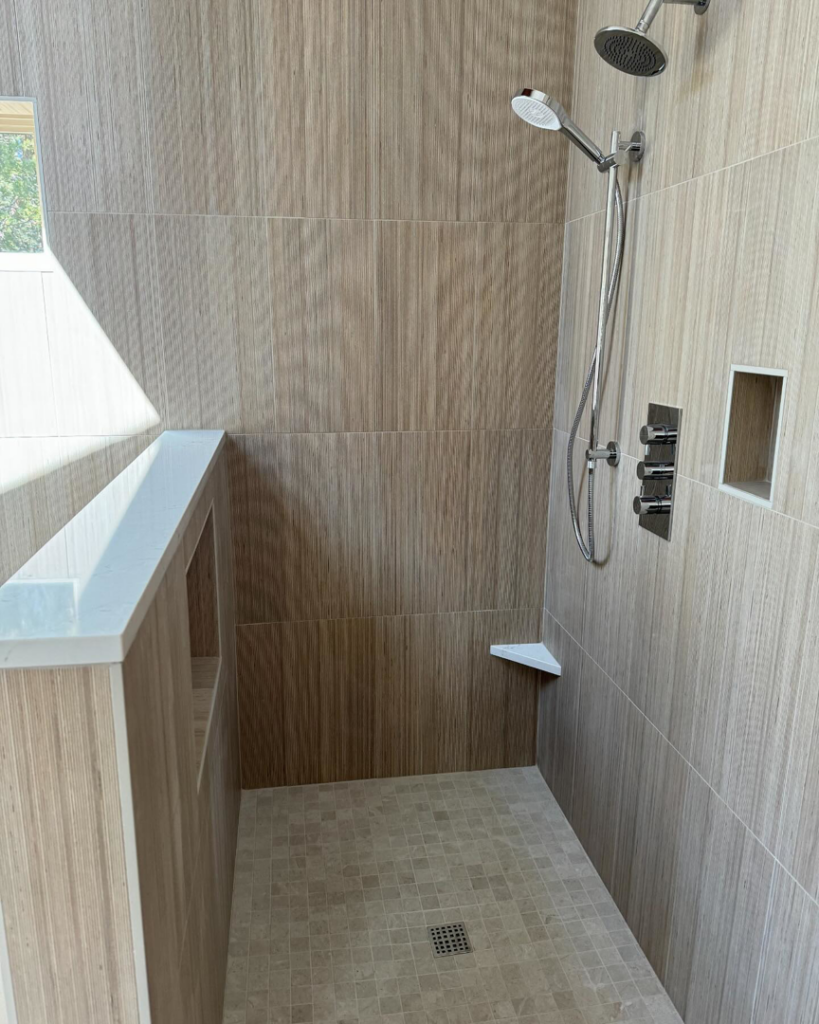 An interior view of a beautifully tiled walk-in shower remodel by Nelson Tile and Stone in Bend, OR.