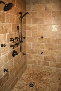 A custom tiled walk-in shower with multiple shower heads, installed by Pro Renovations Savannah, GA.