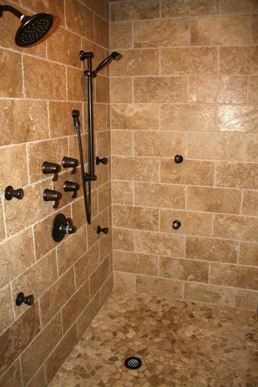 A custom tiled walk-in shower with multiple shower heads, installed by Pro Renovations Savannah, GA.