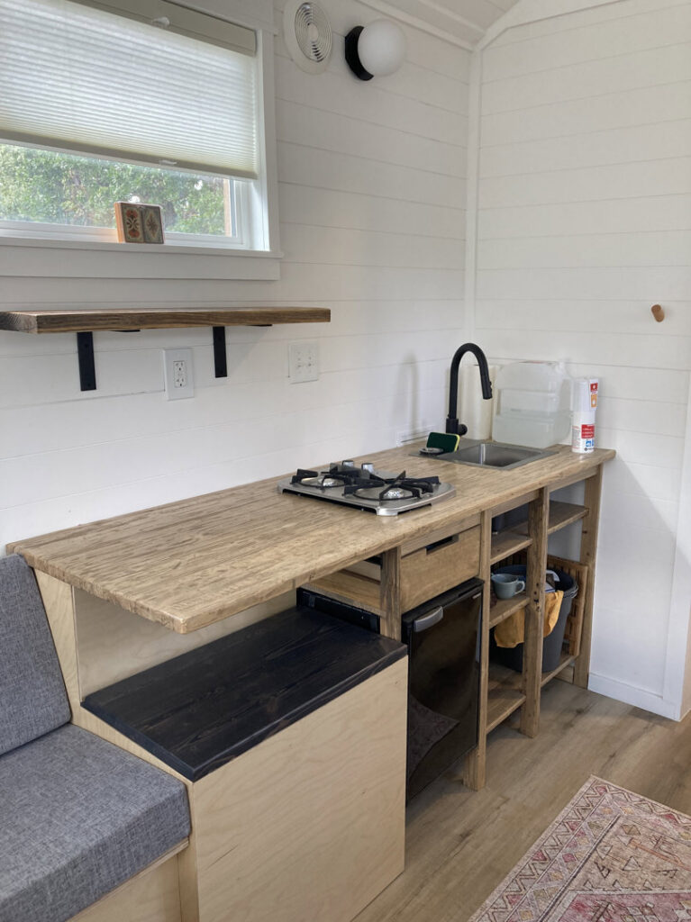 Custom kitchenette installation with wooden countertops in a tiny home by Top Shelf Handyman Pros in Post Falls, ID